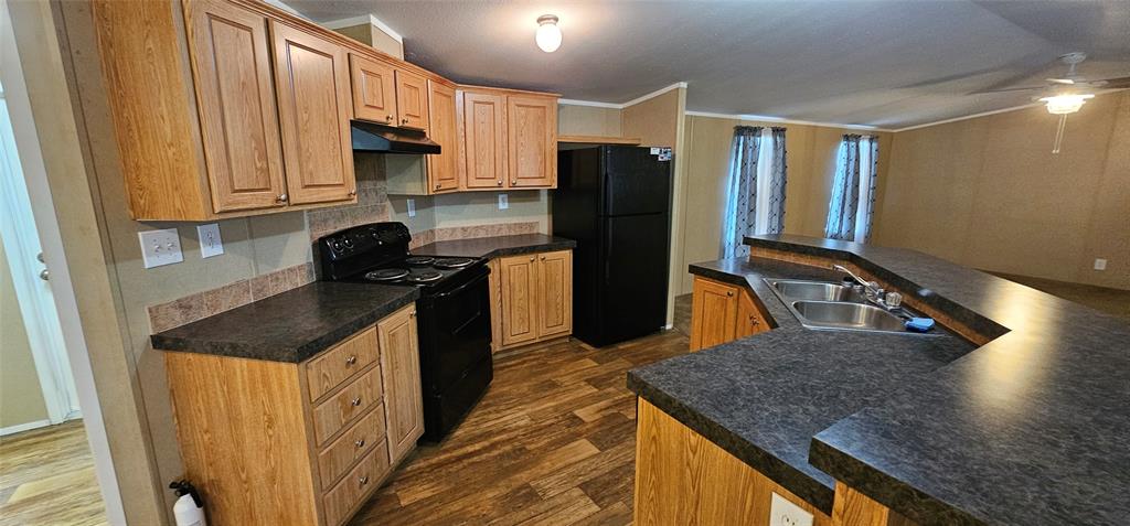 434 Geronimo Quitman, TX 75783 - Photo 15 of 36 a kitchen with a sink a refrigerator and a stove top oven