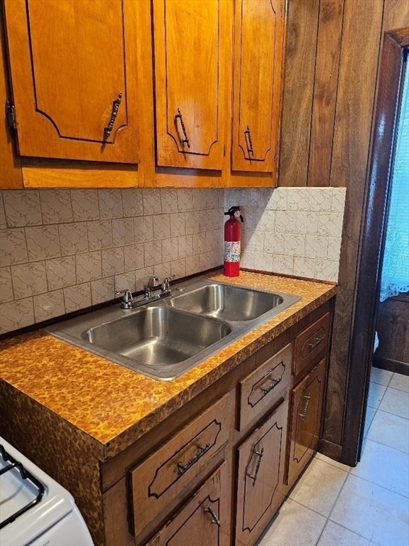 339 Harrison Street, Unit 1N Fall River, MA 02723 - Photo 2 of 14 a kitchen with a sink a stove and cabinets