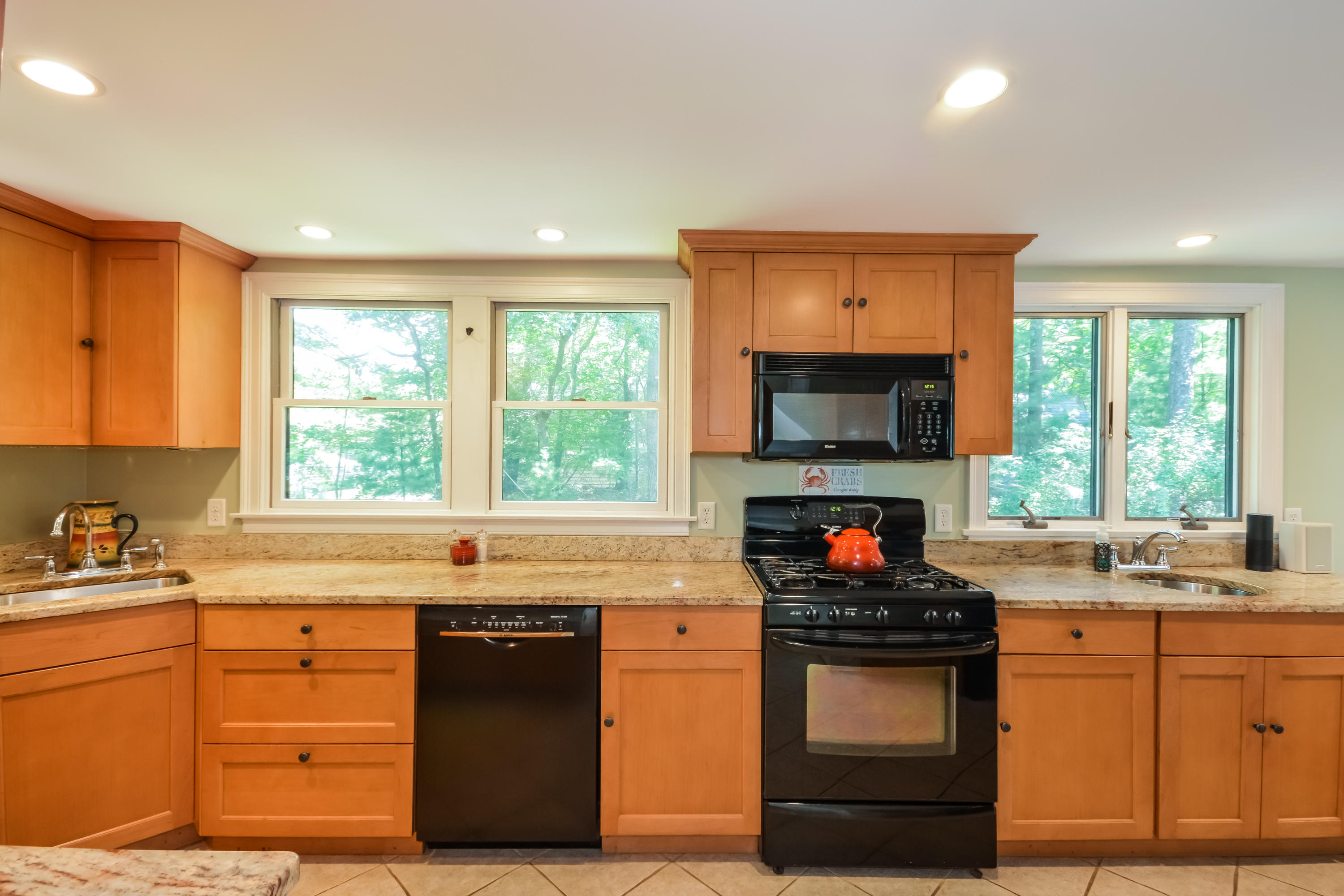 60 Clay Pond Road Bourne, MA 02532 - Photo 8 of 32 a kitchen with granite countertop a stove top oven sink and cabinets