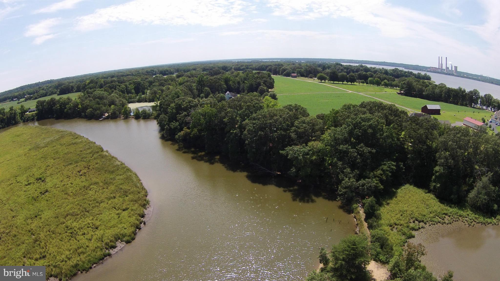 2071 Lowery Road Huntingtown, MD 20639 - Photo 18 of 27 a view of a lake with a yard and mountain in the back