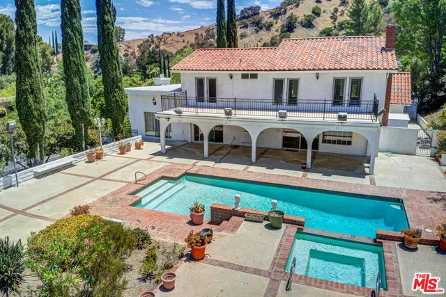 a view of a patio with table and chairs with wooden fence
