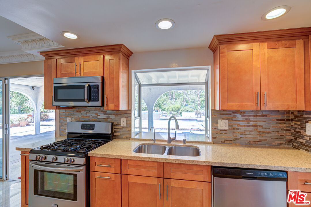 4041 Alonzo Avenue Encino, CA 91316 - Photo 16 of 41 a kitchen with a stove a sink and a microwave