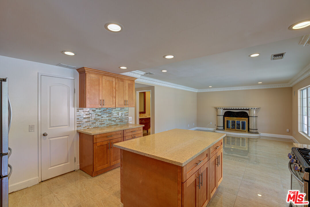 4041 Alonzo Avenue Encino, CA 91316 - Photo 18 of 41 a kitchen with stainless steel appliances granite countertop a refrigerator and a stove