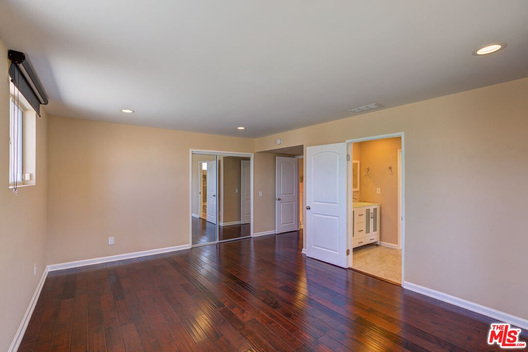 4041 Alonzo Avenue Encino, CA 91316 - Photo 24 of 41 a view of an empty room with wooden floor and a window