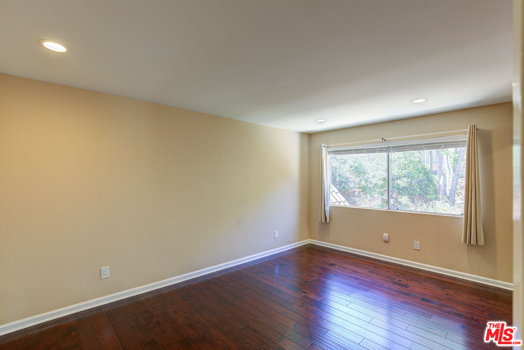 4041 Alonzo Avenue Encino, CA 91316 - Photo 26 of 41 an empty room with wooden floor and windows