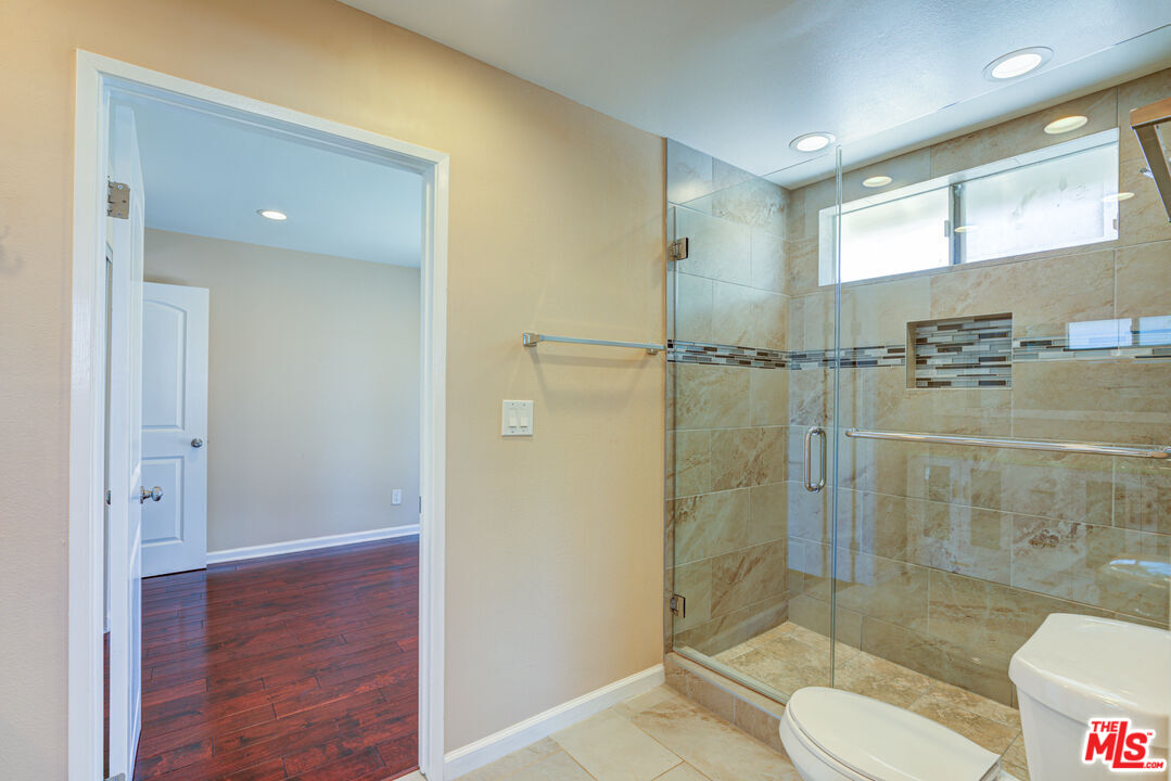 4041 Alonzo Avenue Encino, CA 91316 - Photo 32 of 41 a bathroom with a shower and toilet