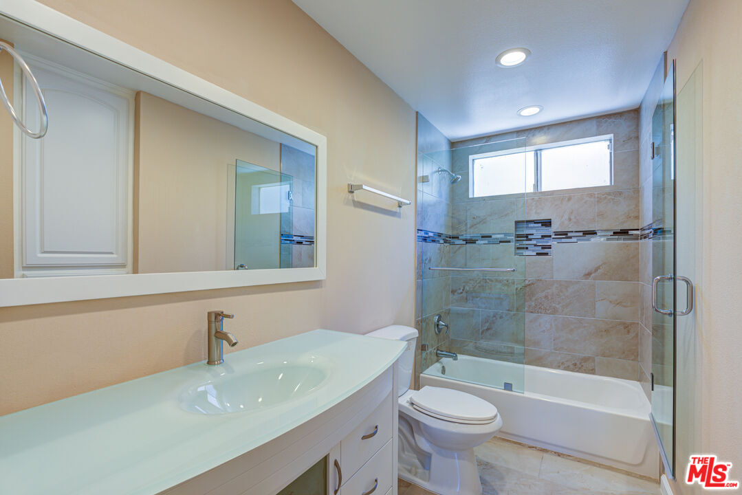 4041 Alonzo Avenue Encino, CA 91316 - Photo 33 of 41 a bathroom with a sink a toilet and shower