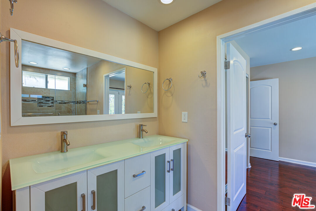 4041 Alonzo Avenue Encino, CA 91316 - Photo 34 of 41 a bathroom with a sink and a mirror
