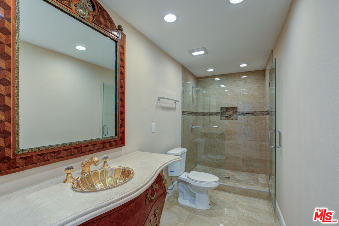 4041 Alonzo Avenue Encino, CA 91316 - Photo 35 of 41 a bathroom with a sink a toilet and shower