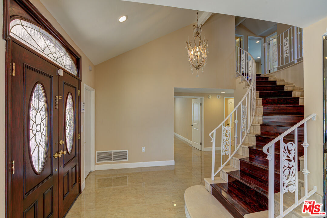 4041 Alonzo Avenue Encino, CA 91316 - Photo 36 of 41 a view of staircase with railing and frames on wall
