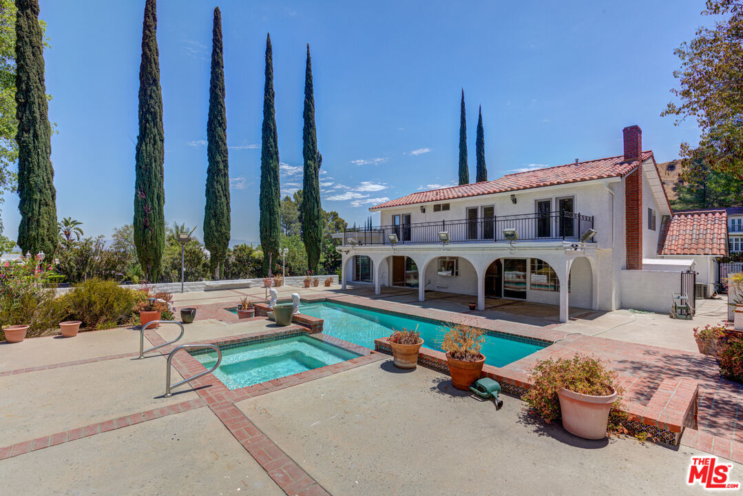 4041 Alonzo Avenue Encino, CA 91316 - Photo 37 of 41 a front view of a house with garden and outdoor seating