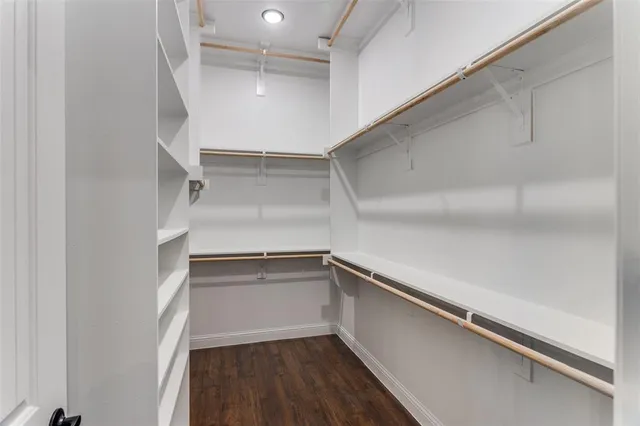 a view of walk in closet with empty racks