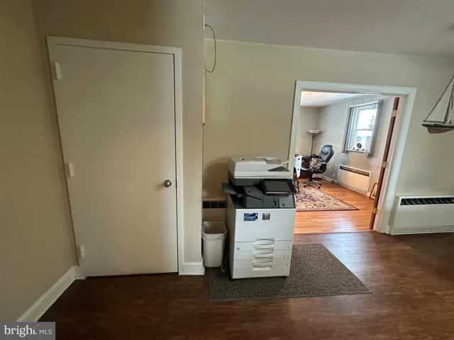 a view of living room with furniture and wooden floor