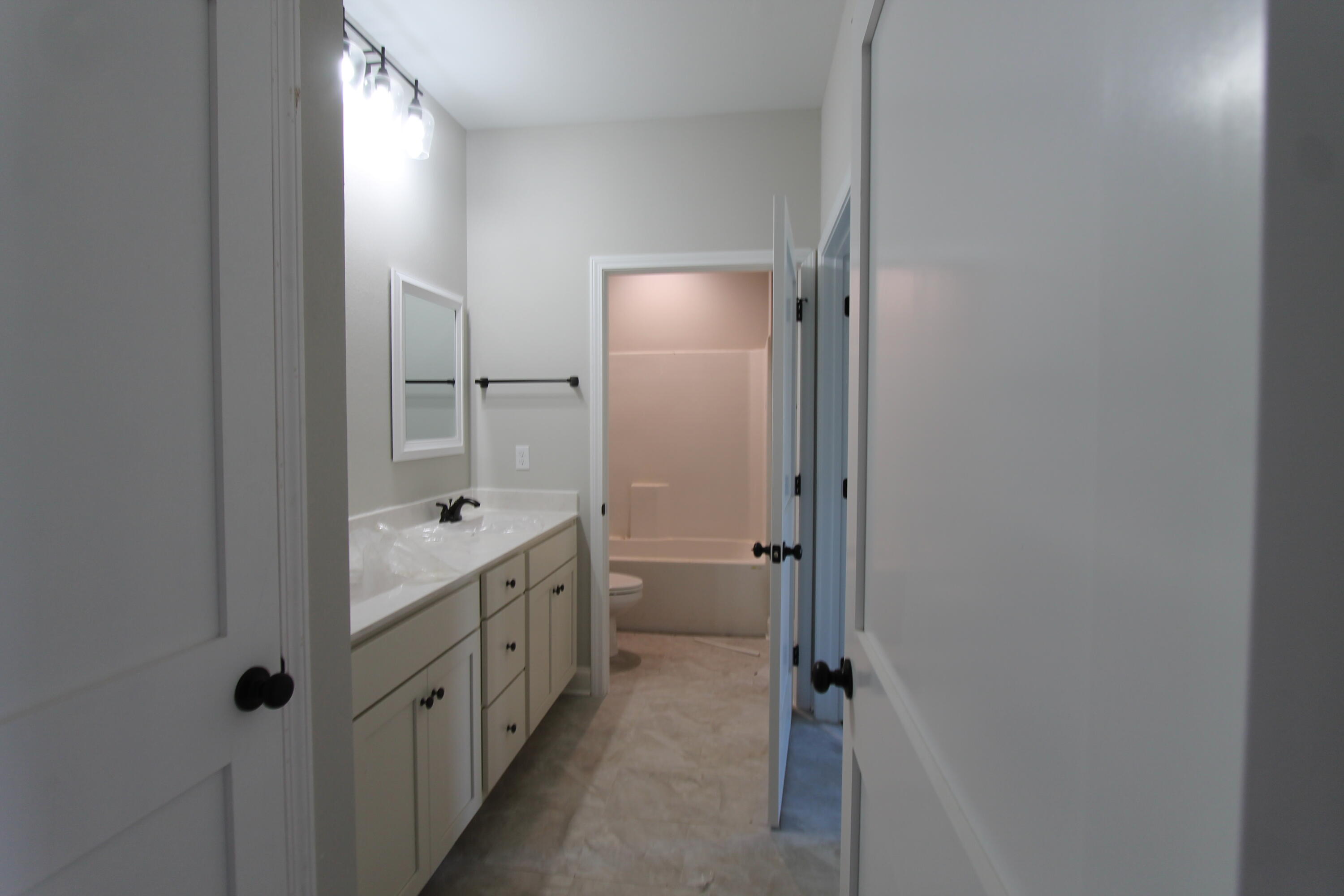 2135 Nina Street Navarre, FL 32566 - Photo 7 of 7 a bathroom with a double vanity sink toilet and shower