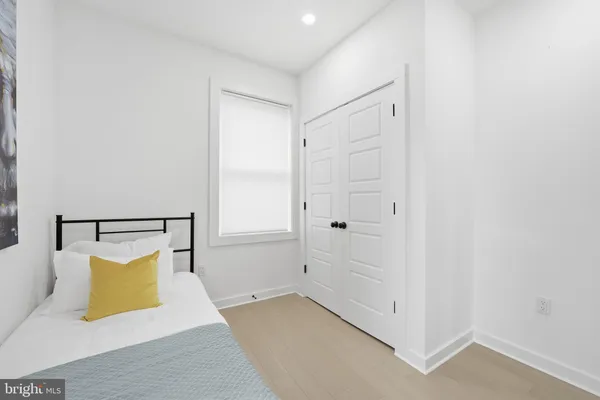 a view of a bedroom with a bed and a potted plant