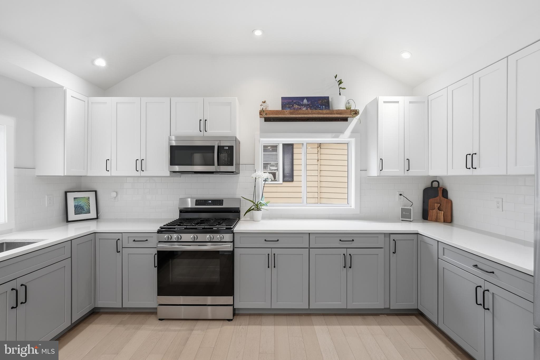 2211 Franklin Street Northeast Washington, DC 20018 - Photo 16 of 39 a kitchen with white cabinets and appliances