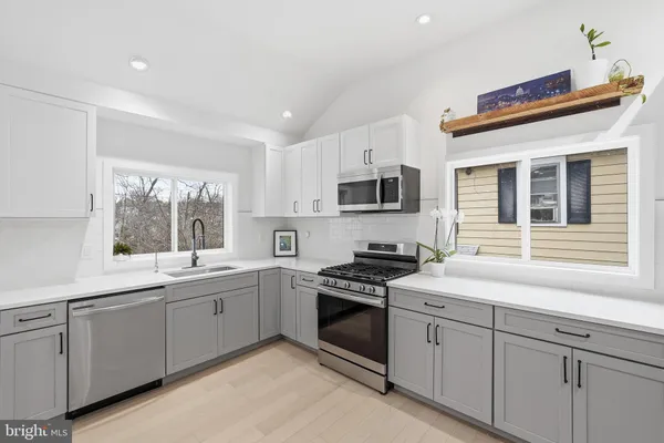 a kitchen that has a sink and cabinets