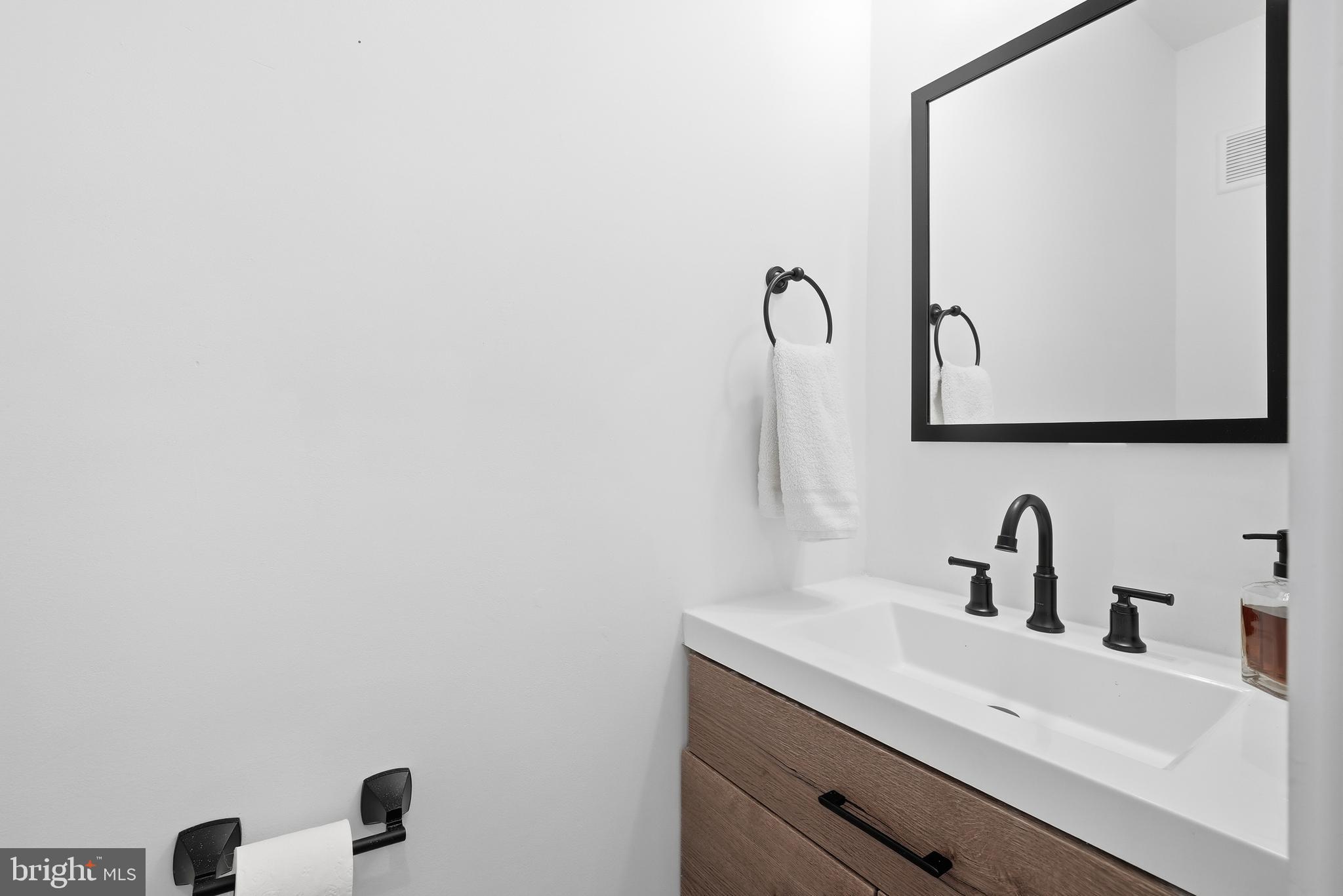 2211 Franklin Street Northeast Washington, DC 20018 - Photo 19 of 39 a bathroom with a sink and mirror