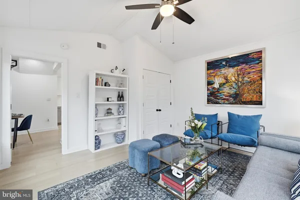 a living room with furniture and wooden floor