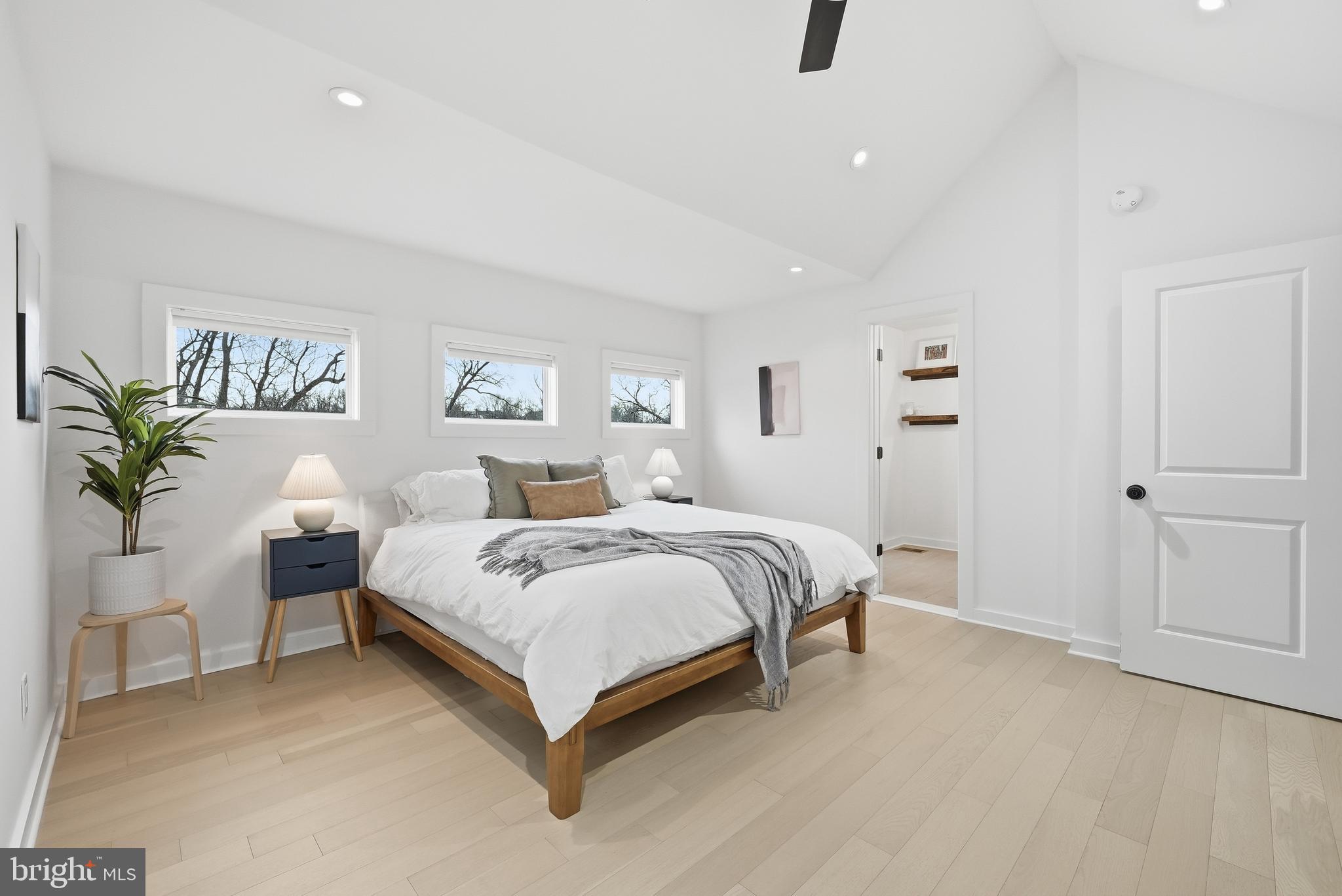 2211 Franklin Street Northeast Washington, DC 20018 - Photo 23 of 39 a spacious bedroom with a bed and a potted plant
