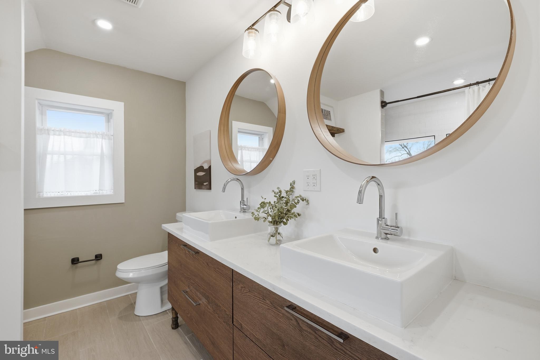 2211 Franklin Street Northeast Washington, DC 20018 - Photo 25 of 39 a bathroom with a sink and a mirror
