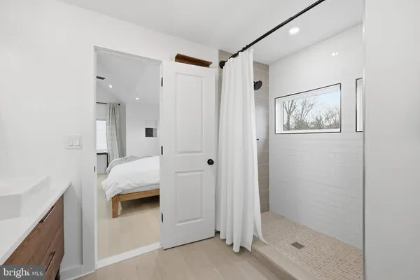 a bathroom with a tub shower and sink