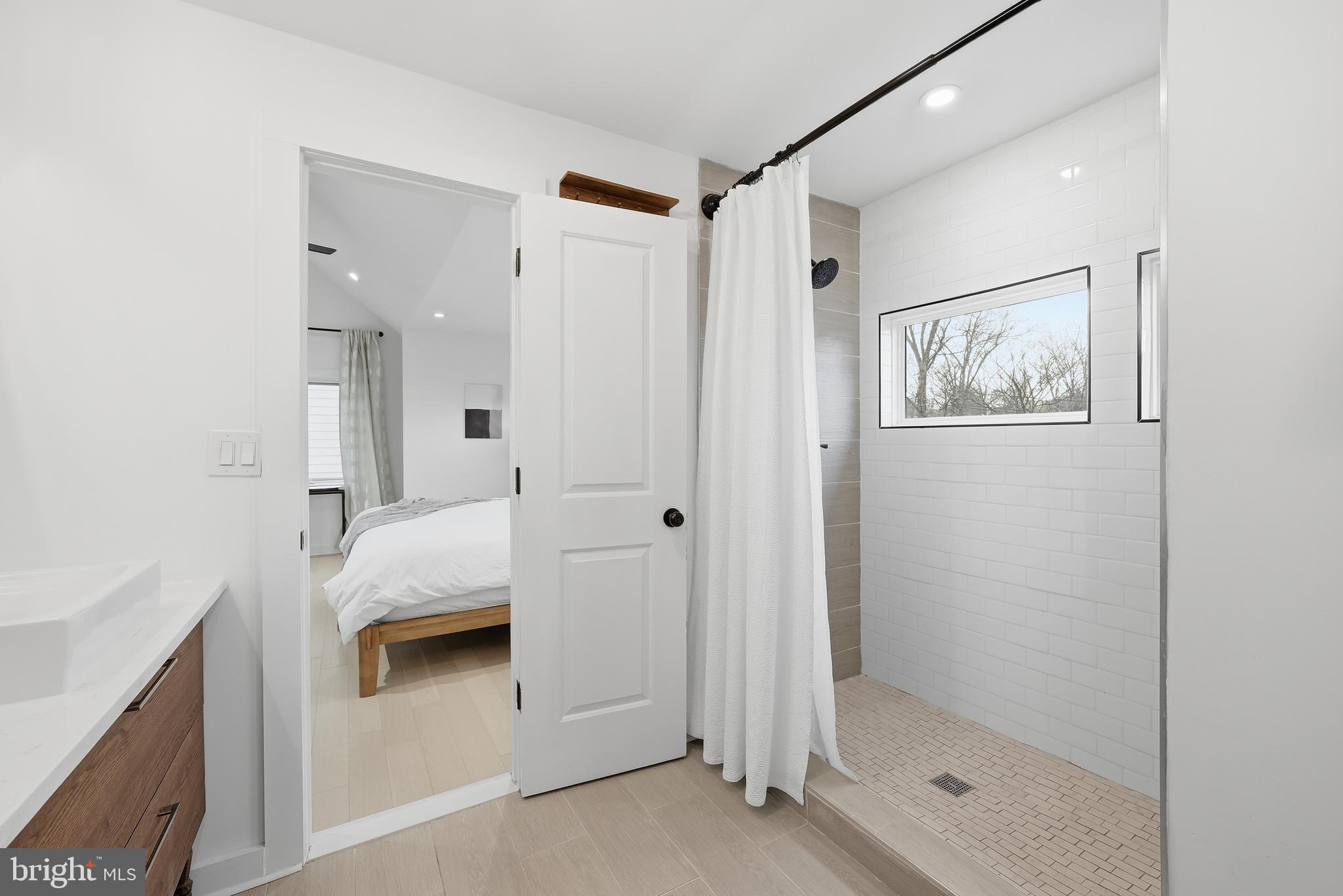 2211 Franklin Street Northeast Washington, DC 20018 - Photo 26 of 39 a bathroom with a tub shower and sink