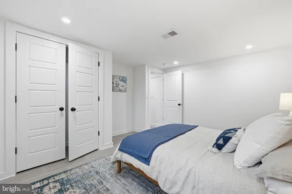 a bedroom with a bed and a closet