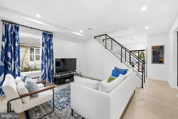 a living room with furniture or stairs and a flat screen tv
