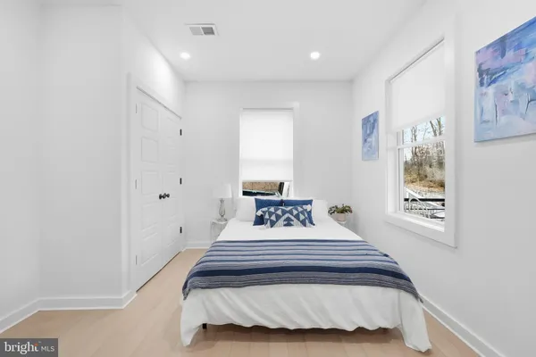 a bedroom with a bed and a window