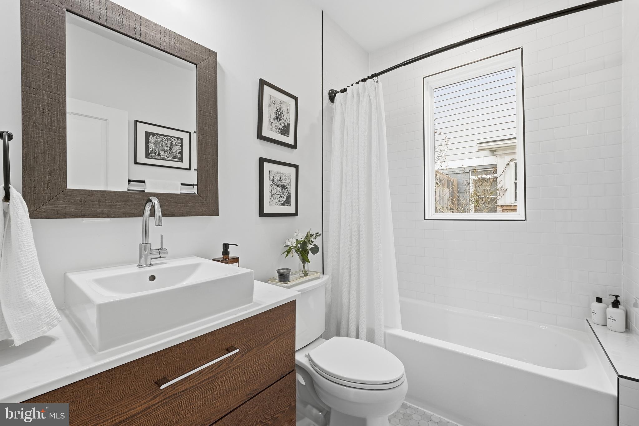 2211 Franklin Street Northeast Washington, DC 20018 - Photo 9 of 39 a bathroom with a sink a toilet and shower