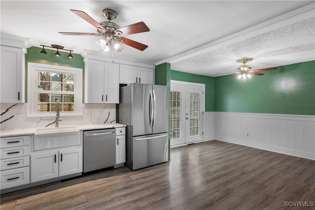 1325 Unison Drive Midlothian, VA 23113 - Photo 14 of 32 a kitchen with kitchen island white cabinets and stainless steel appliances