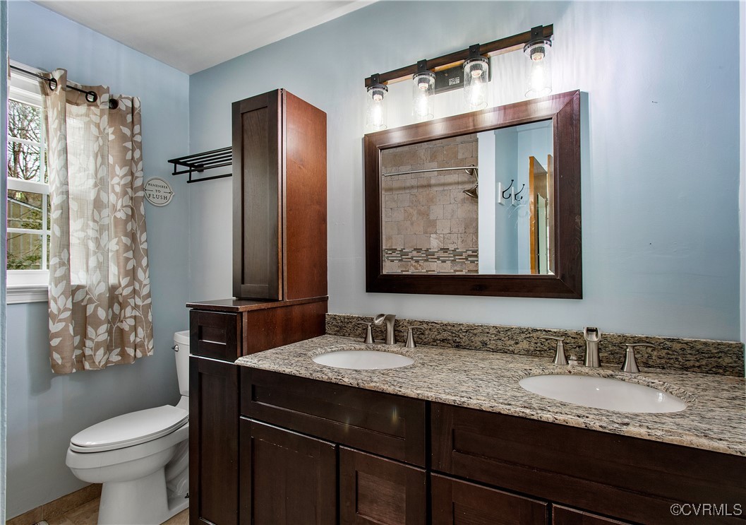 1325 Unison Drive Midlothian, VA 23113 - Photo 24 of 32 a bathroom with a granite countertop sink toilet and shower