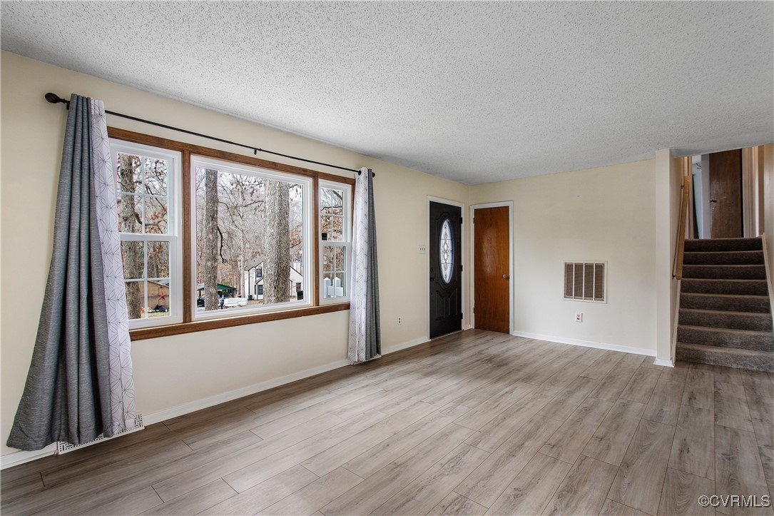 1325 Unison Drive Midlothian, VA 23113 - Photo 6 of 32 a view of a big room with wooden floor and windows