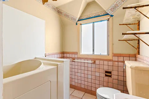 a bathroom with a sink toilet a mirror and shower