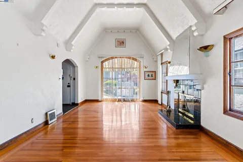 wooden floor in an empty room with a fireplace