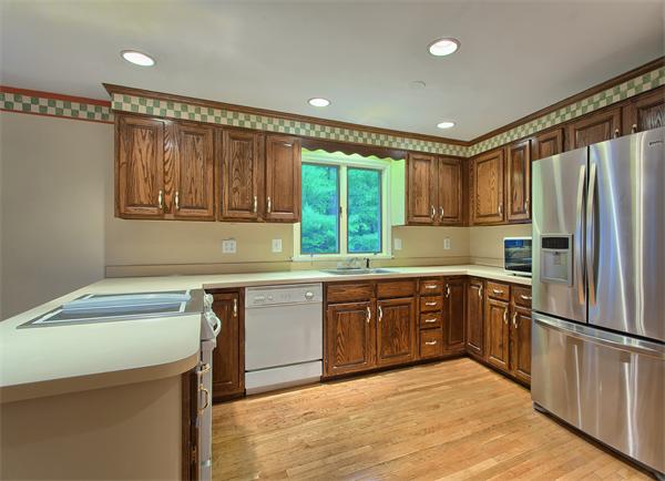 31 Bayberry Road Groton, MA 01450 - Photo 8 of 15 a kitchen with granite countertop a sink stainless steel appliances and cabinets