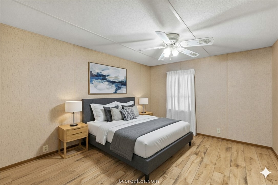 12044 Fm 2155 Somerville, TX 77879 - Photo 5 of 16 a bedroom with a large bed and a chandelier