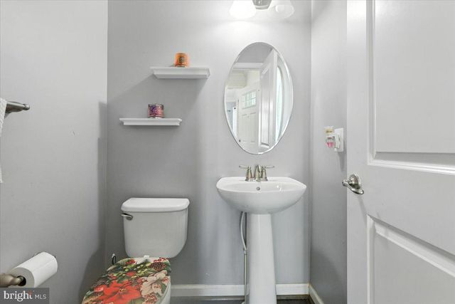 a spacious bedroom with a large bed and a chandelier