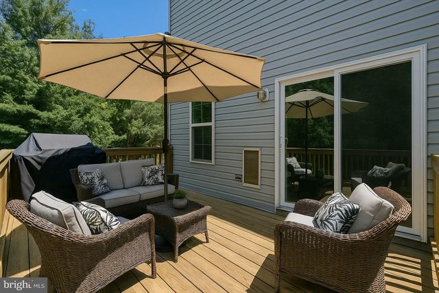 a view of a livingroom with furniture and a flat screen tv