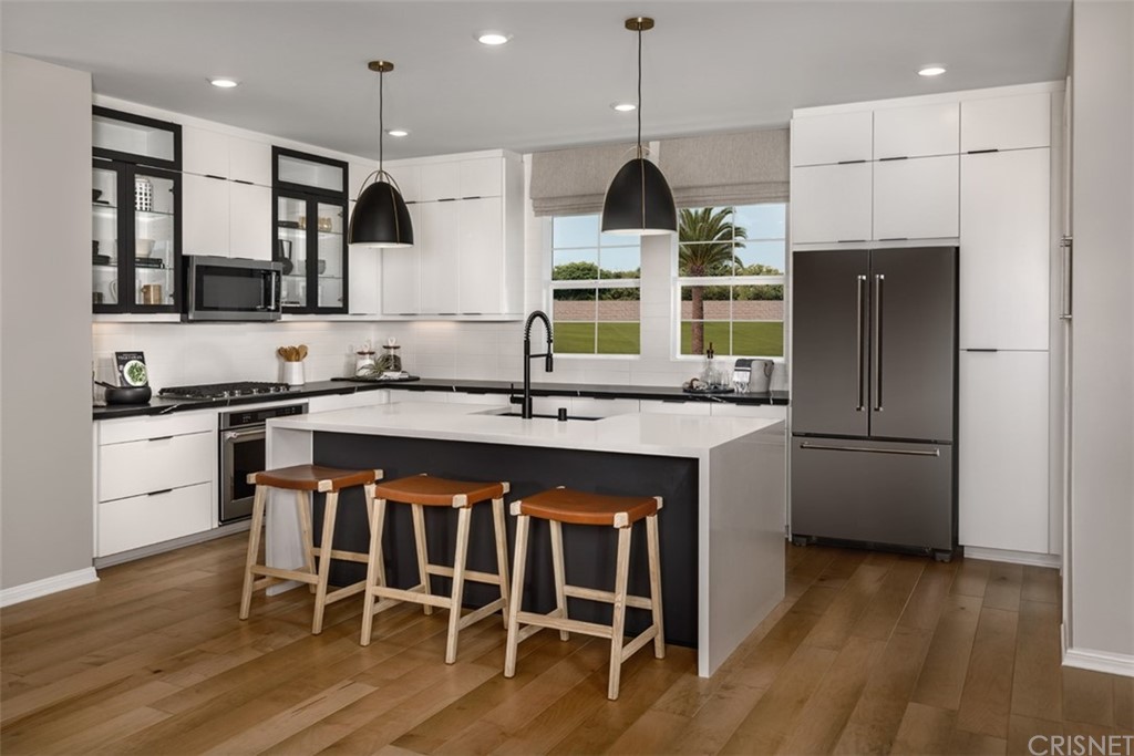 27706 Limestone Drive Ripon, CA 95366 - Photo 5 of 8 a kitchen with granite countertop a stove a sink and a refrigerator