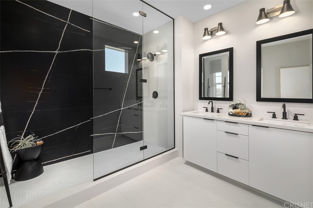 27706 Limestone Drive Ripon, CA 95366 - Photo 7 of 8 a bathroom with a double vanity sink a mirror and a shower