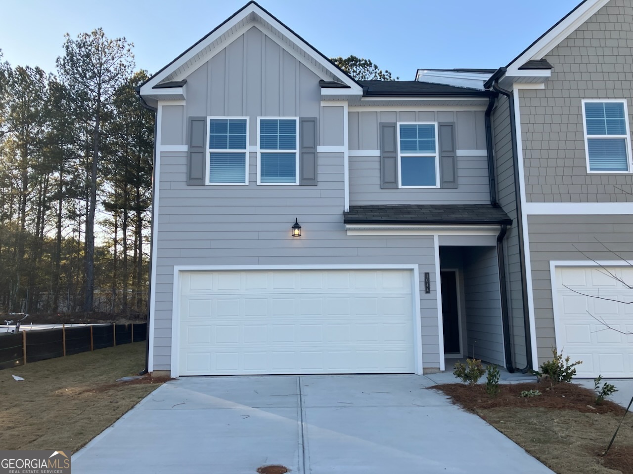 a front view of a house with garage