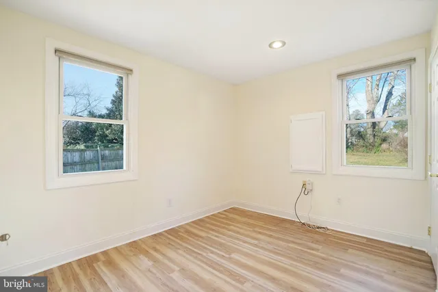 a view of a room with wooden floor and windows