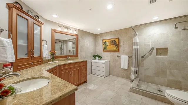 a large bathroom with a double vanity sink a large mirror and a bathtub