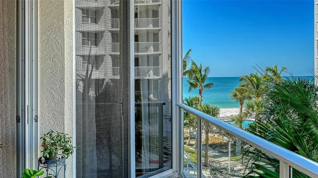 a view of a balcony with a plant and stairs