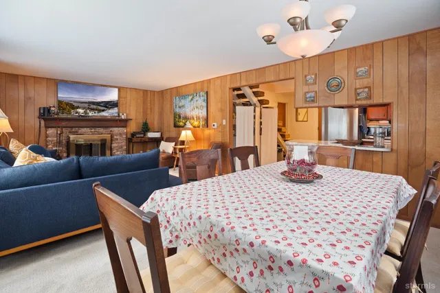 a view of a a dining room with furniture window and wooden floor