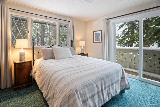 a bedroom with a large bed and a large window