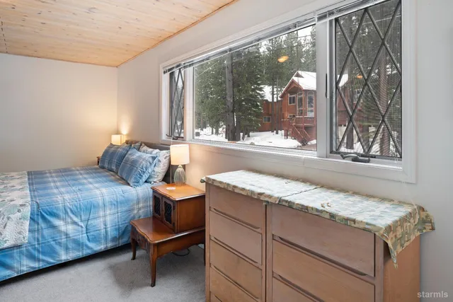 a living room with a bed and a table