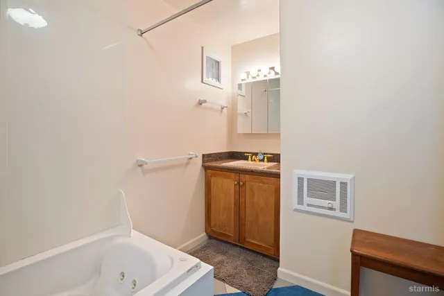 a bathroom with a tub and sink